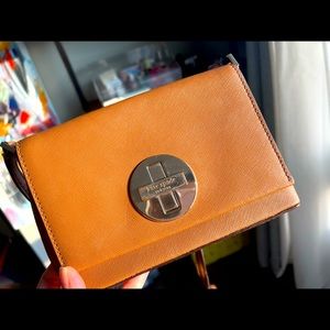 Small cross body bag by Kate Spade in gold